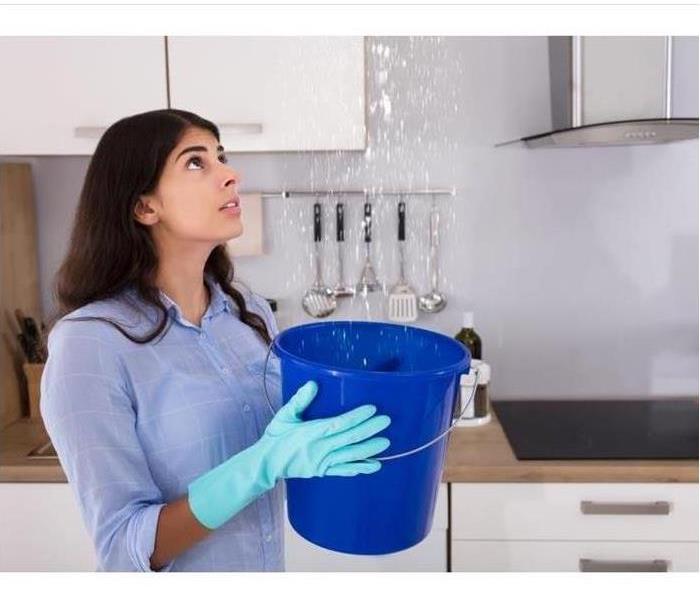 Woman catching Water with bucket