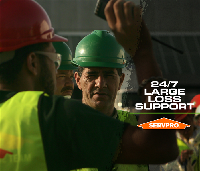 SERVPRO restoration crew gathered outside a business with the caption: "24/7 LARGE LOSS SUPPORT